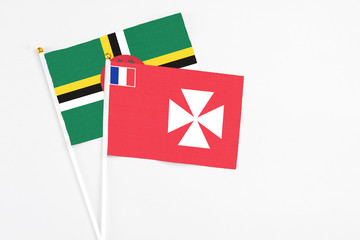 Wallis And Futuna and Dominica stick flags on white background. High quality fabric, miniature national flag. Peaceful global concept.White floor for copy space.