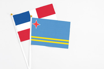 Aruba and Dominican Republic stick flags on white background. High quality fabric, miniature national flag. Peaceful global concept.White floor for copy space.