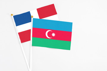 Azerbaijan and Dominican Republic stick flags on white background. High quality fabric, miniature national flag. Peaceful global concept.White floor for copy space.