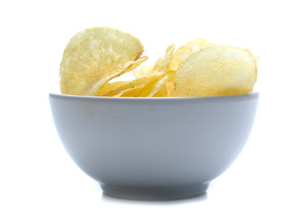 Potato chips on bowl isolated on white
