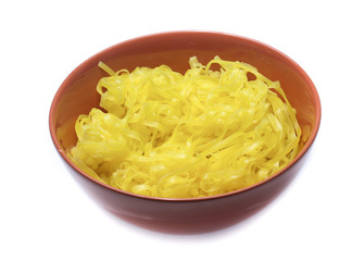 yellow noodles on bowl isolated on white background