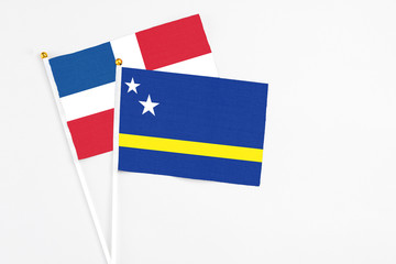 Curacao and Dominican Republic stick flags on white background. High quality fabric, miniature national flag. Peaceful global concept.White floor for copy space.