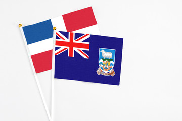 Falkland Islands and Dominican Republic stick flags on white background. High quality fabric,...