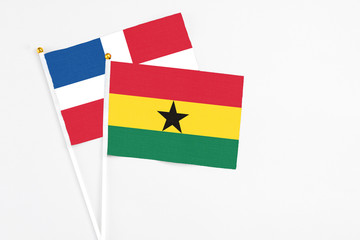 Ghana and Dominican Republic stick flags on white background. High quality fabric, miniature national flag. Peaceful global concept.White floor for copy space.