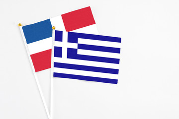 Greece and Dominican Republic stick flags on white background. High quality fabric, miniature national flag. Peaceful global concept.White floor for copy space.