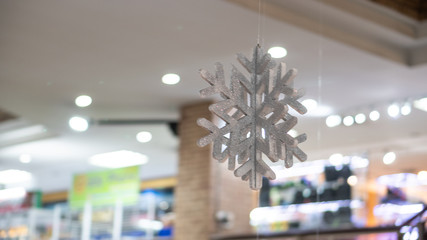 The symbol of a snowflake hanging in a mall in Thailand for the coming winter.