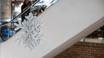 Snowflake symbol hanging beside the stairs in a sales mall in Thailand