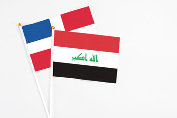 Iraq and Dominican Republic stick flags on white background. High quality fabric, miniature national flag. Peaceful global concept.White floor for copy space.