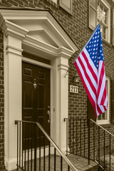 American flag in front of typical american houses