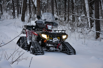 ATV on tracks stands on a snowy road in the taiga © Vladimir Chebanov