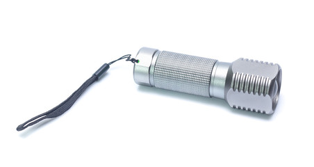 Metal flashlight over white background