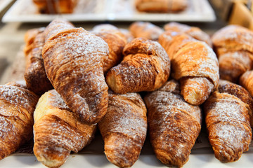 Sweet french croissant pastry with jam and cream in cafe and bakery. Crescent cake at patisserie. Food for breakfast. Beautiful fresh baked desert. Gourmet and cuisine on table. Homemade Dessert