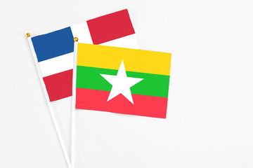 Myanmar and Dominican Republic stick flags on white background. High quality fabric, miniature national flag. Peaceful global concept.White floor for copy space.