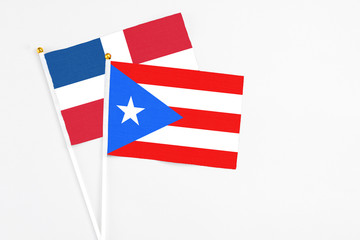 Puerto Rico and Dominican Republic stick flags on white background. High quality fabric, miniature national flag. Peaceful global concept.White floor for copy space.