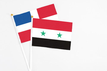 Syria and Dominican Republic stick flags on white background. High quality fabric, miniature...