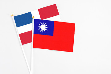 Taiwan and Dominican Republic stick flags on white background. High quality fabric, miniature national flag. Peaceful global concept.White floor for copy space.