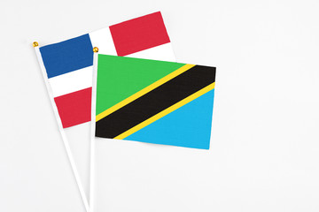 Tanzania and Dominican Republic stick flags on white background. High quality fabric, miniature national flag. Peaceful global concept.White floor for copy space.