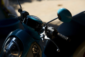 shiny light of reflection in star shape from metal part of motorcycle or motorbike