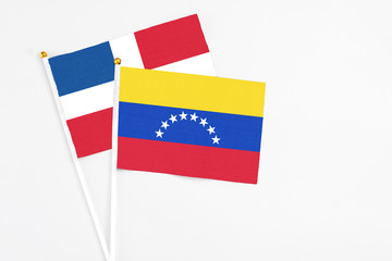 Venezuela and Dominican Republic stick flags on white background. High quality fabric, miniature national flag. Peaceful global concept.White floor for copy space.