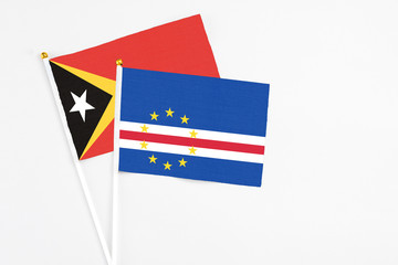Cape Verde and East Timor stick flags on white background. High quality fabric, miniature national flag. Peaceful global concept.White floor for copy space.