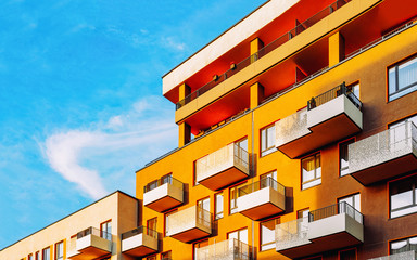 Part in Modern residential flat with apartment building exterior. Detail of New luxury house and home complex. Fragment of City Real estate property and condo architecture. Copy space. Blue sky