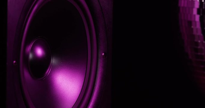 CLOSE UP moving sub-woofer music speakers vibrating membrane colorful pulsing light disco ball