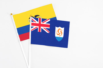 Anguilla and Ecuador stick flags on white background. High quality fabric, miniature national flag. Peaceful global concept.White floor for copy space.