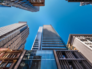 Looking up from George Street at major landmark towers with MidCity Shopping Centre in the middle in Sydney City, Australia.