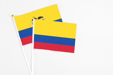 Colombia and Ecuador stick flags on white background. High quality fabric, miniature national flag. Peaceful global concept.White floor for copy space.