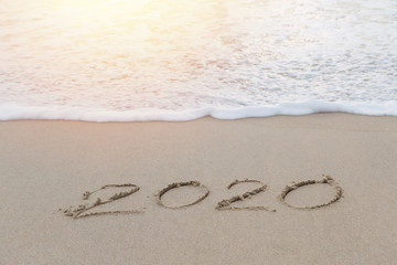 2020 written in the sand on the beach