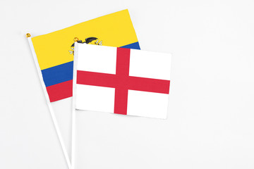 England and Ecuador stick flags on white background. High quality fabric, miniature national flag. Peaceful global concept.White floor for copy space.