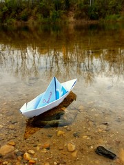 Memorial paper boat is launched on to a small pond