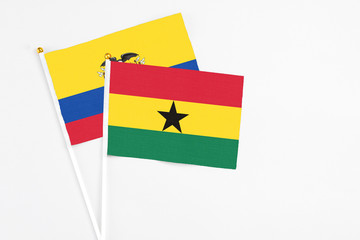 Ghana and Ecuador stick flags on white background. High quality fabric, miniature national flag. Peaceful global concept.White floor for copy space.