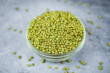 Green mung beans in bowl on gray background - Mung bean seed cereal whole grains