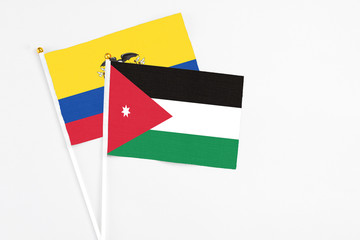 Jordan and Ecuador stick flags on white background. High quality fabric, miniature national flag. Peaceful global concept.White floor for copy space.