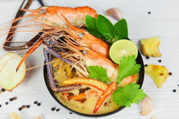 Tom Yum Kung thai food asian traditional - Prawn spicy soup bowl cooked seafood with shrimp soup dinner table and spices ingredients