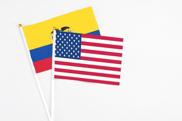 United States and Ecuador stick flags on white background. High quality fabric, miniature national flag. Peaceful global concept.White floor for copy space.