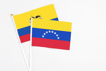 Venezuela and Ecuador stick flags on white background. High quality fabric, miniature national flag. Peaceful global concept.White floor for copy space.