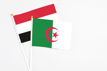 Algeria and Egypt stick flags on white background. High quality fabric, miniature national flag. Peaceful global concept.White floor for copy space.