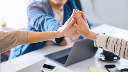 Group of businessman putting their hands together in the meeting