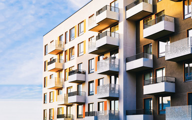 Part of Modern residential flat apartment building exterior. Detail of New luxury house and home complex. Fragment of City Real estate property and condo architecture. Copy space. Blue sky