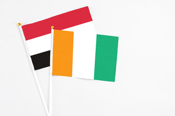 Cote D'Ivoire and Egypt stick flags on white background. High quality fabric, miniature national flag. Peaceful global concept.White floor for copy space.