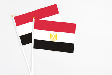 Egypt and Egypt stick flags on white background. High quality fabric, miniature national flag. Peaceful global concept.White floor for copy space.