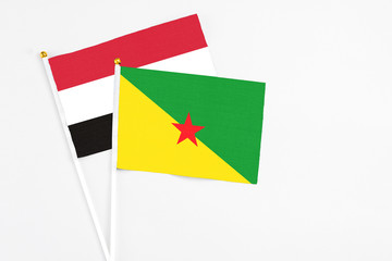 French Guiana and Egypt stick flags on white background. High quality fabric, miniature national flag. Peaceful global concept.White floor for copy space.