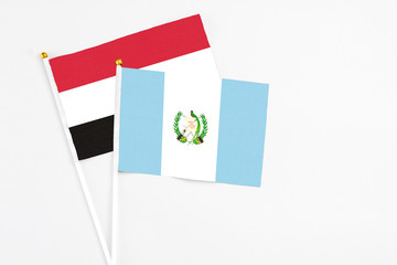 Guatemala and Egypt stick flags on white background. High quality fabric, miniature national flag. Peaceful global concept.White floor for copy space.