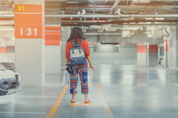 A lonely Asian woman forgot and  can't find her car at underground parking after the mall is closed.