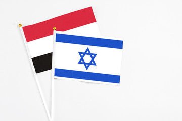 Israel and Egypt stick flags on white background. High quality fabric, miniature national flag. Peaceful global concept.White floor for copy space.