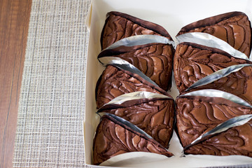 Fresh Chocolate brownie cake portions on wooden background, Top view