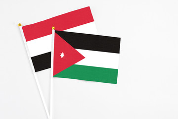 Jordan and Egypt stick flags on white background. High quality fabric, miniature national flag. Peaceful global concept.White floor for copy space.
