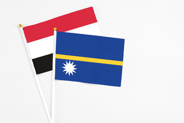 Nauru and Egypt stick flags on white background. High quality fabric, miniature national flag. Peaceful global concept.White floor for copy space.